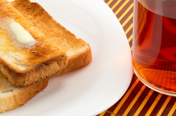 Hot toast with butter and cup of tea