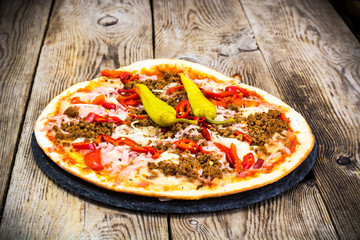 Rustic Italian Pizza on a Thin Pastry with Minced Pork, Ham, Tom