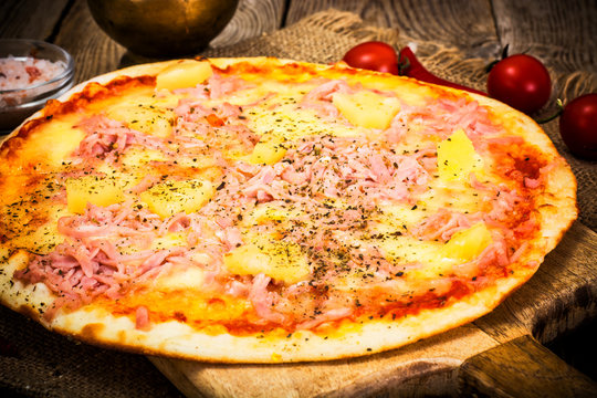 Hawaiian Pizza on a Thin Pastry with Ham, Meat and Pineapple. St