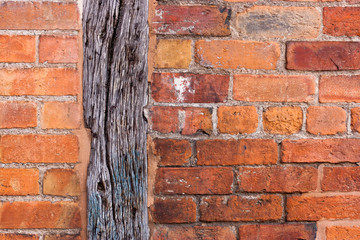 Abstract texture background of old red brick wall built with grey brown wooden beam