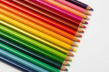Fototapeta premium Lápices de colores en fila sobre fondo aislado blanco