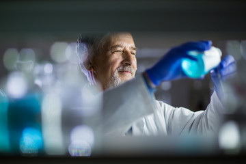 Senior male researcher carrying out scientific research in a lab
