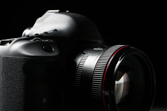 Professional modern DSLR camera low key stock photo/image 