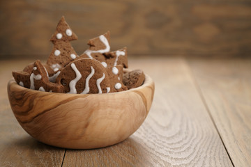 chrismas chocolate cookies in wooden bowl on oak table with copy space