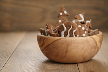 chrismas chocolate cookies in wooden bowl on oak table with copy space