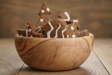 chrismas chocolate cookies in wooden bowl on oak table