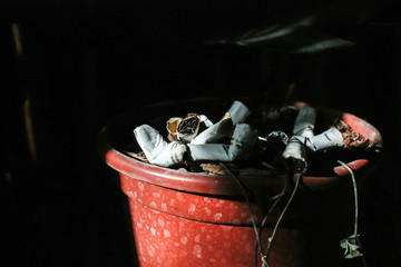 Cigarette butts on a black background
