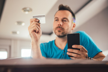 Man paying with credit card on smart phone