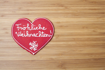 Christmas heart shaped decoration on wooden background with plen
