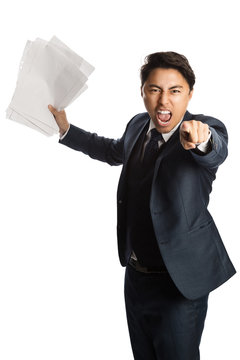 Totally frustrated businessman holding a bunch of paper about to throw them in the air, wearing a blue suit, vest and tie. White background.