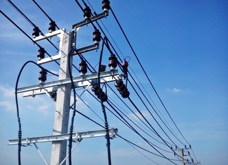 Electric pole connect to the high voltage electric wires on blue sky background