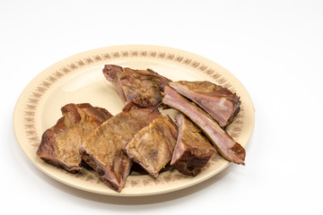 Raw smoked ribs on the plate over white background