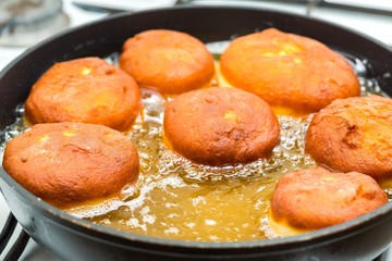 Donuts frying in deep fat