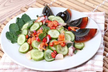 Close up spicy cucumber salad with dried-shrimp and  preserved e