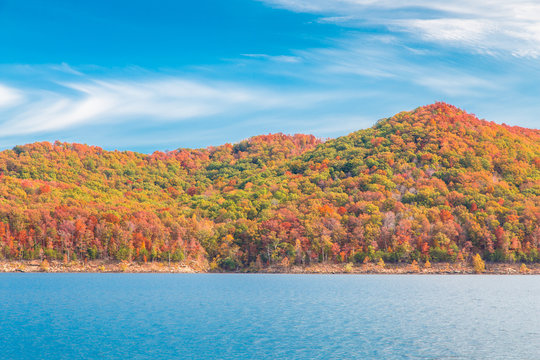 Autumn season at lake with beautiful forest at hill shore.