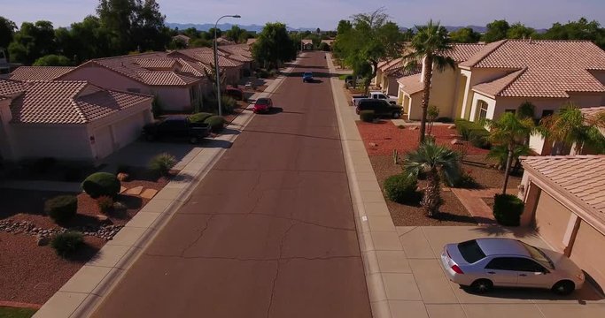 A Truck Drives Past Homes In A Typical Arizona Neighborhood. Phoenix Suburbs.  	