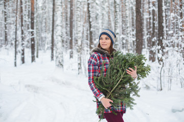 girl keeps fir branches in the winter forest