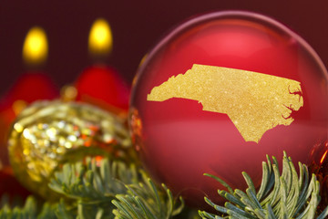 Red bauble with the golden shape of North Carolina.(series)
