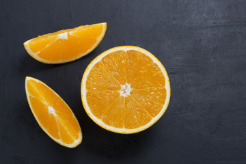 fresh orange fruit on wooden table in black
