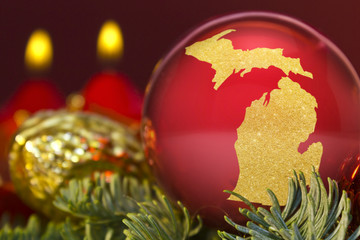 Fototapeta na wymiar Red bauble with the golden shape of Michigan.(series)