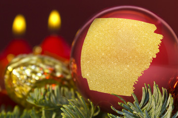 Red bauble with the golden shape of Arkansas.(series)