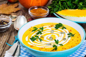 Spicy pumpkin carrot soup with  seeds and curry  fresh