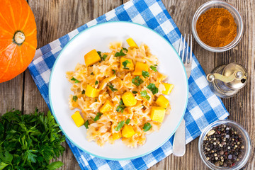 Farfalle with slices of pumpkin and parsley