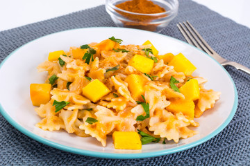Farfalle with slices of pumpkin and parsley