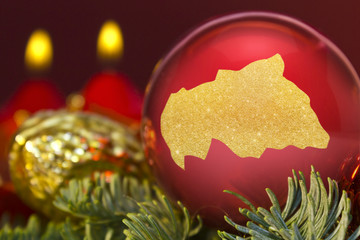 Red bauble with the golden shape of Central African Republic.(se