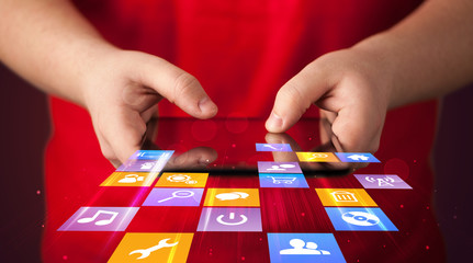 Hand holding tablet device with media application