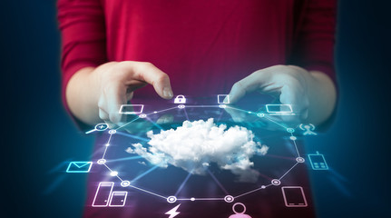 Close up of hand holding tablet with cloud network technology