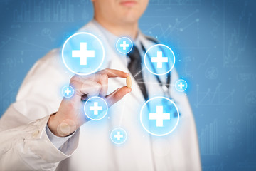 A doctor showing a pill with crosses