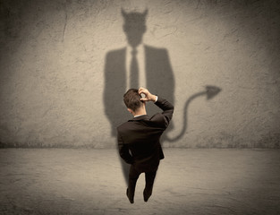 Salesman facing his own devil shadow