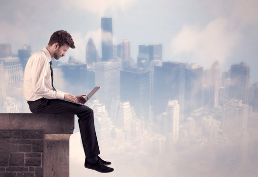 Sales Person Sitting On Top Of A Tall Building