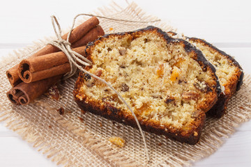 Fresh baked fruitcake with ingredients on boards
