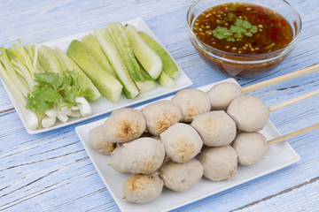 pork ball with sweet spicy sauce on blue wood table