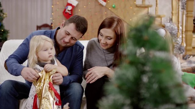 parents don't pay attention to sad daughter at the celebration of christmas