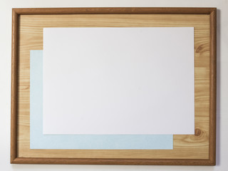 Shot of old wood frame with blank paper inside.