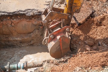 Excavator, bulldozer work a hole the repair of pipe water 