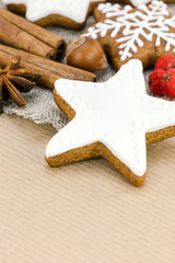 christmas homemade star shaped gingerbread and red berries on brown striped paper background