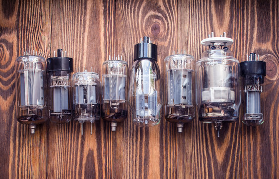 electronic vacuum tubes on the wooden background. closeup view.