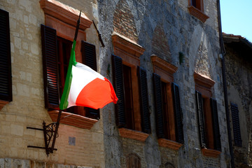 Italian flag and windows with brown window shutters