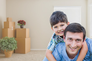Fototapeta na wymiar Happy Father and Son in Room with Packed Moving Boxes and Potted Plants.