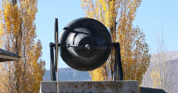Historic school bell rings for Veterans Day celebration. Small patriotic rural community. Children ring bell in memorial to those who have served, were injured and gave their all.