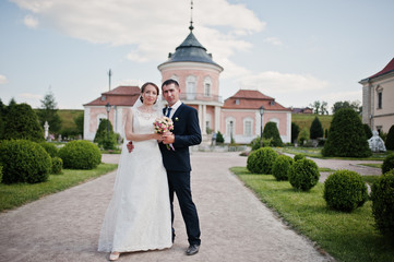 Wedding couple in the yard of castle mansion