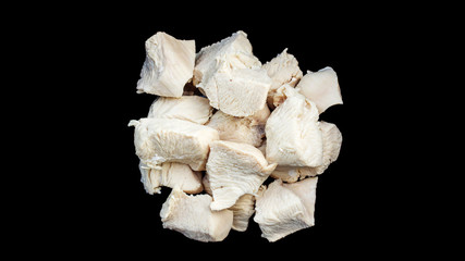 Boiled chicken meat on a black background.