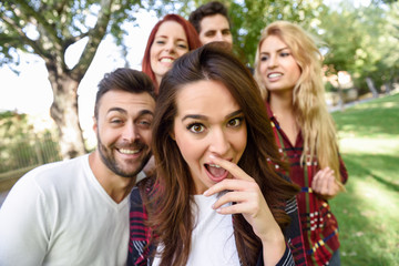 Group of friends taking selfie in urban background