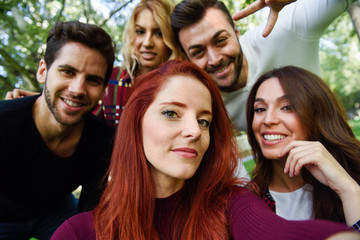 Group of friends taking selfie in urban background