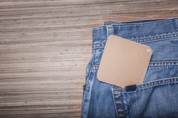 Blue jeans on wooden background with copy space