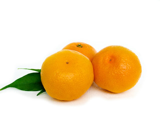 Tangerines with leaves and slices on white background